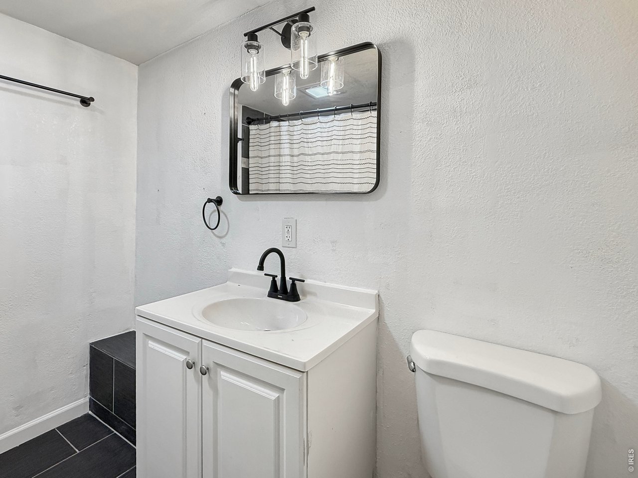 720 Phelps Street Sterling, CO 80751 - Photo 15 of 27 a bathroom with a sink a toilet and mirror