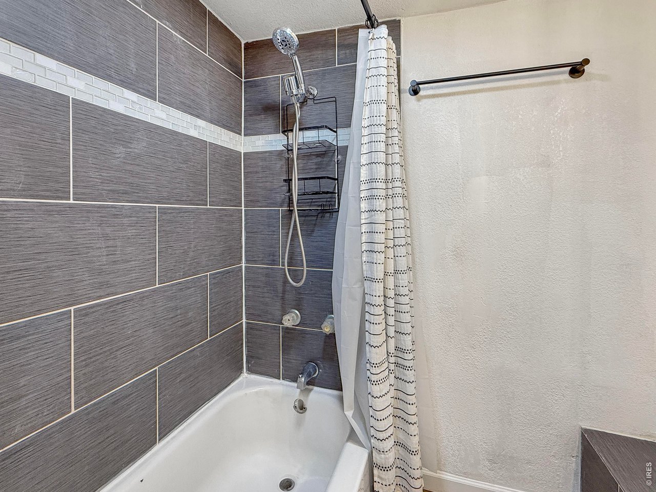 720 Phelps Street Sterling, CO 80751 - Photo 16 of 27 a bathroom with a shower and a sink