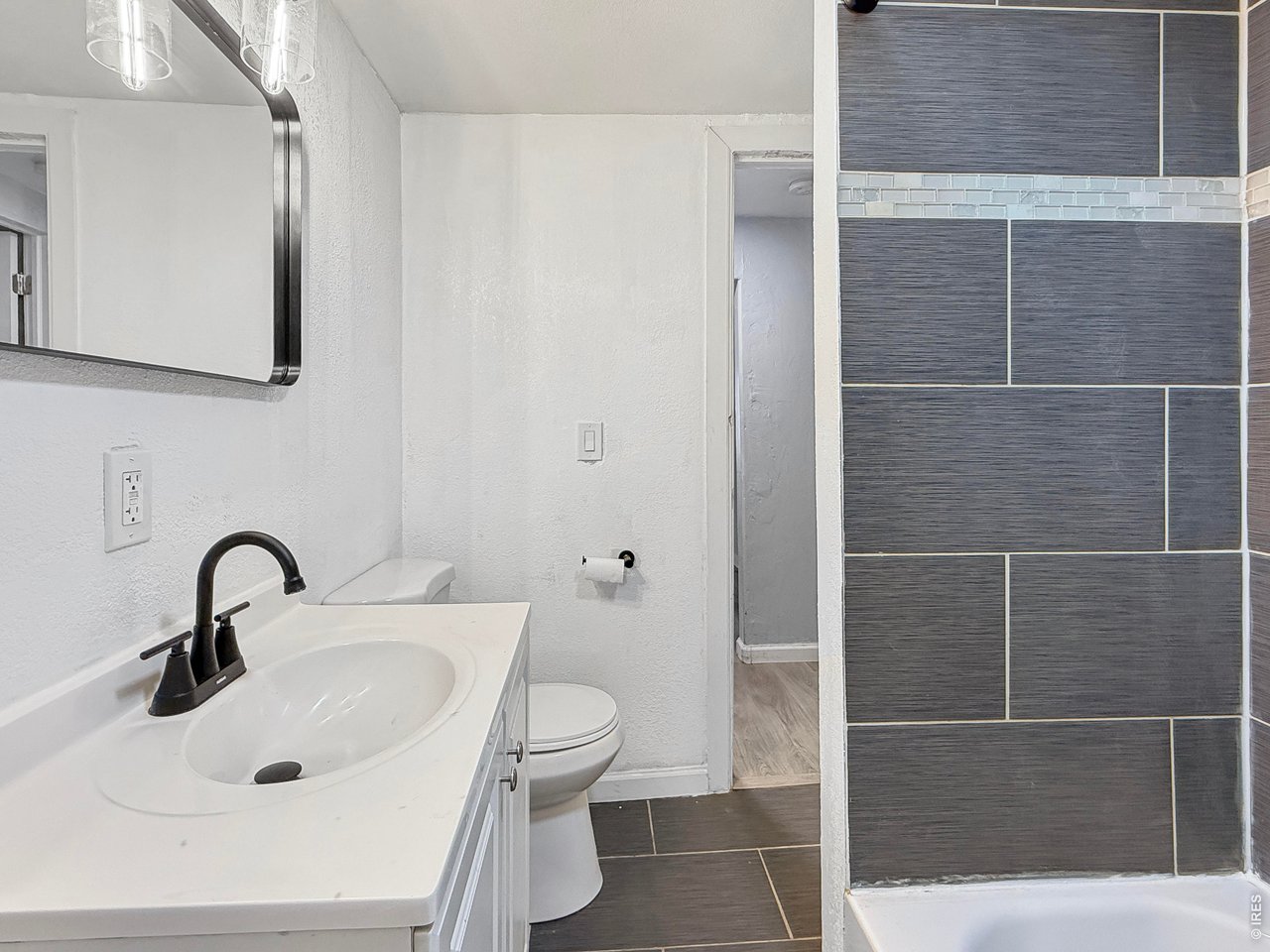 720 Phelps Street Sterling, CO 80751 - Photo 17 of 27 a bathroom with a sink toilet and shower
