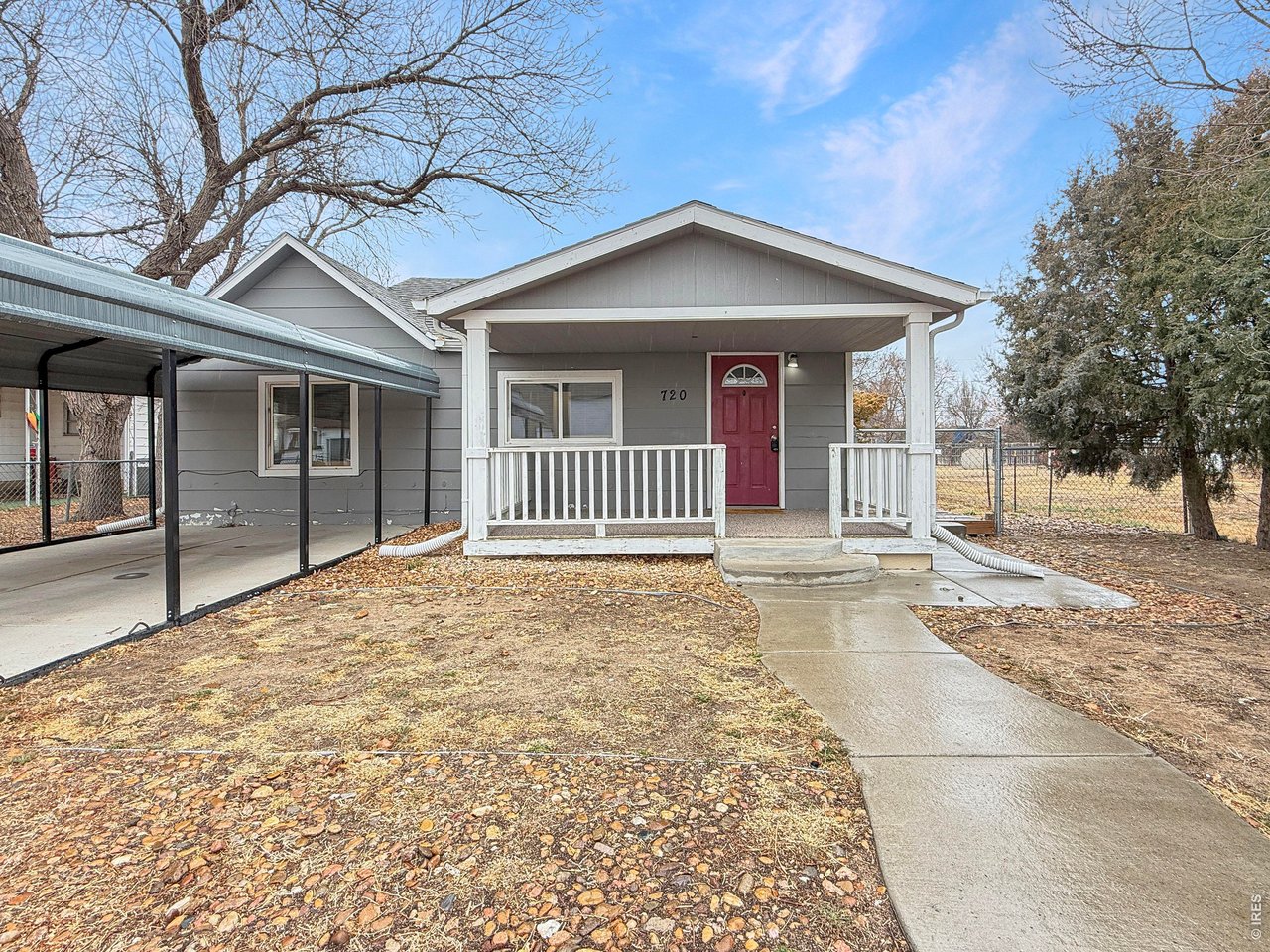720 Phelps Street Sterling, CO 80751 - Photo 2 of 27 a view of a house with a yard