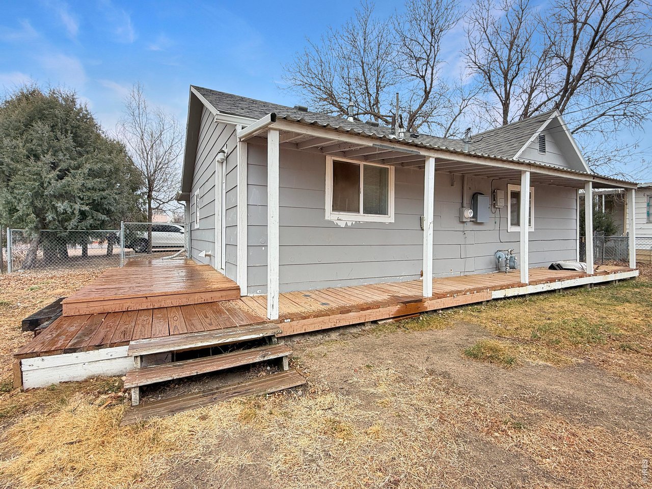 720 Phelps Street Sterling, CO 80751 - Photo 21 of 27 a backyard of a house with wooden floor and fence