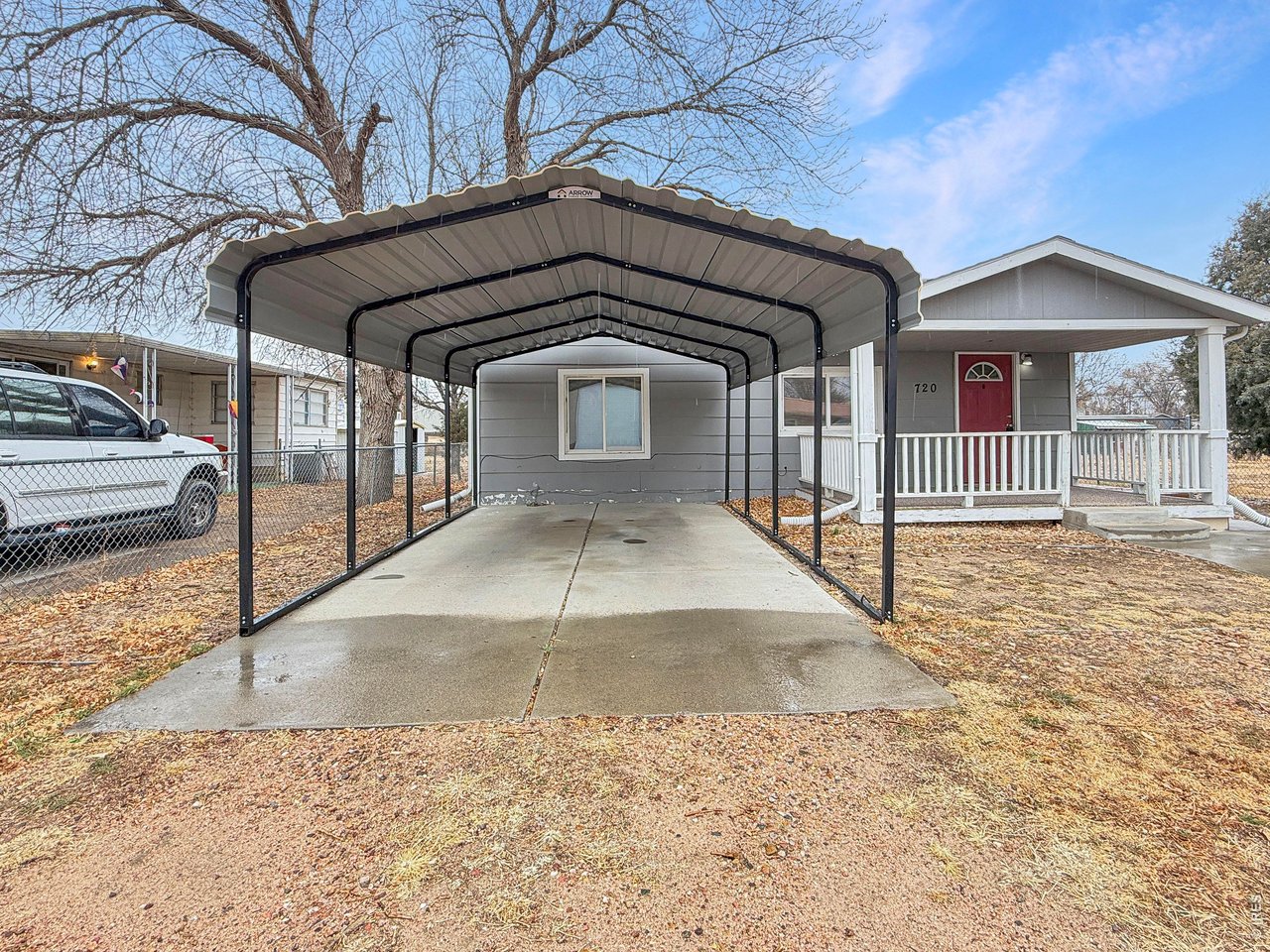 720 Phelps Street Sterling, CO 80751 - Photo 26 of 27 a view of a house with a wooden fence