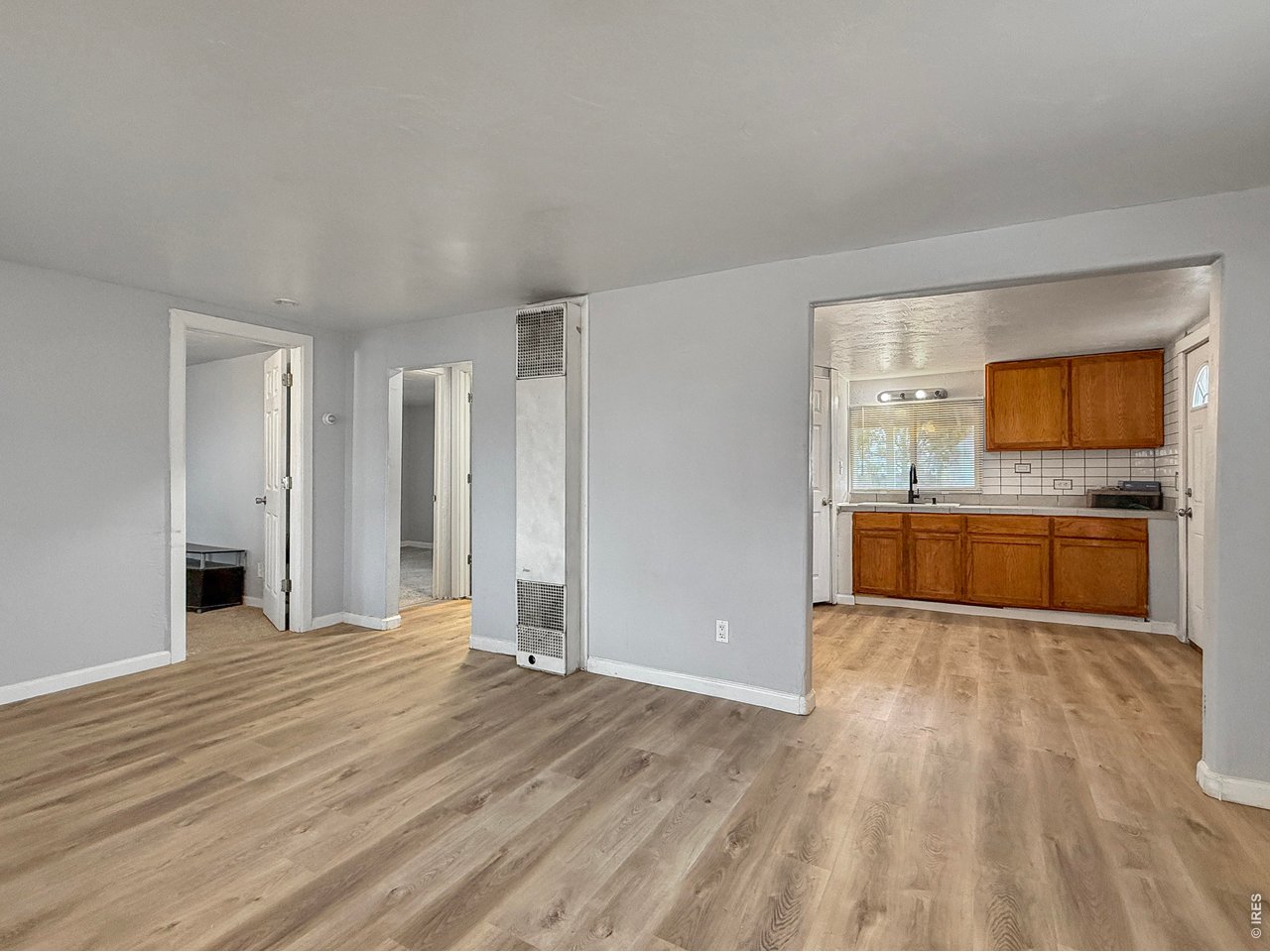 720 Phelps Street Sterling, CO 80751 - Photo 7 of 27 a view of a kitchen with wooden floor and a sink