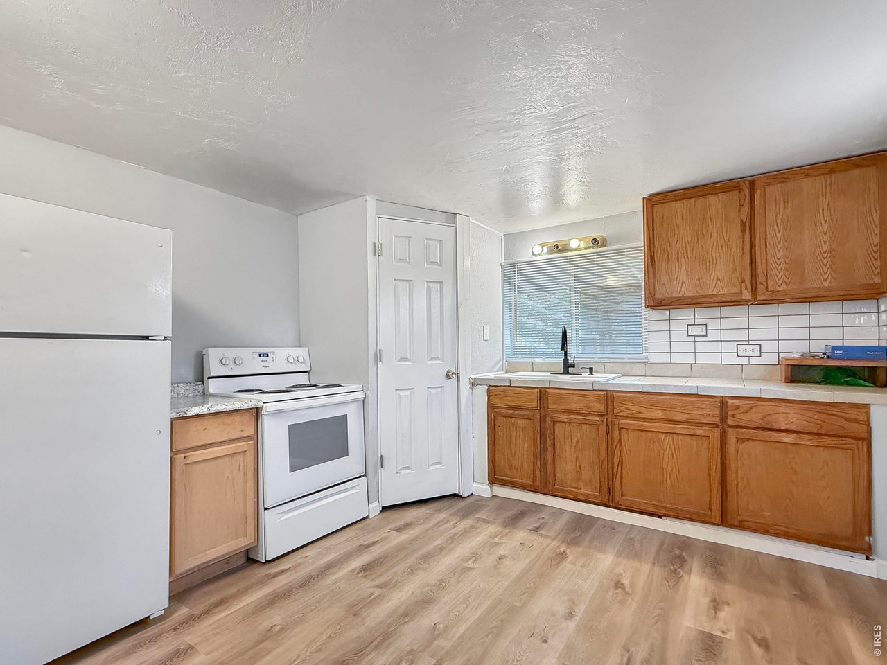 720 Phelps Street Sterling, CO 80751 - Photo 8 of 27 a kitchen with stainless steel appliances granite countertop a stove a sink dishwasher and a refrigerator