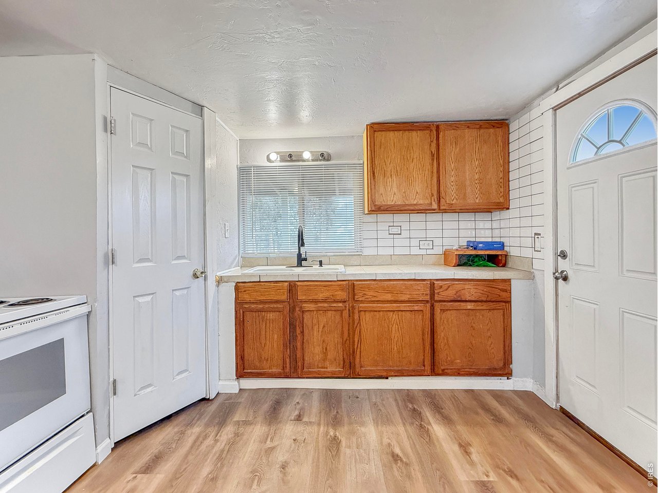 720 Phelps Street Sterling, CO 80751 - Photo 9 of 27 a view of kitchen with granite countertop cabinets and sink
