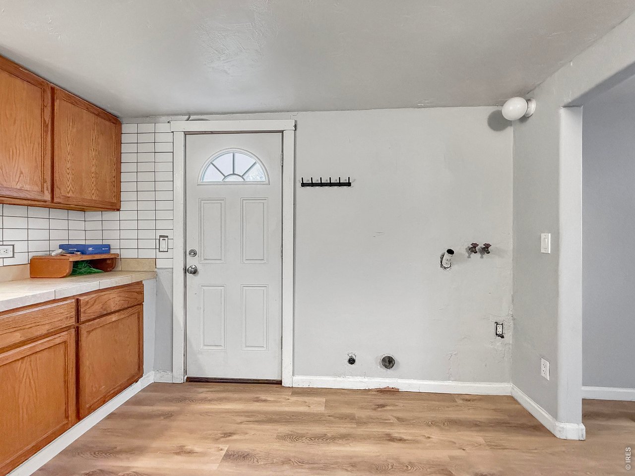 720 Phelps Street Sterling, CO 80751 - Photo 10 of 27 a view of an empty room with window and cabinet