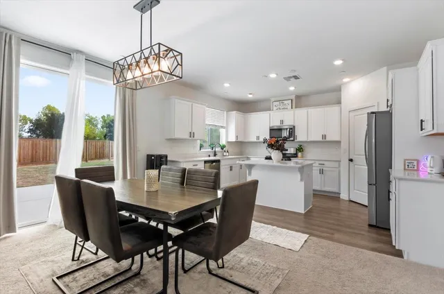 a kitchen with a table and chairs in it
