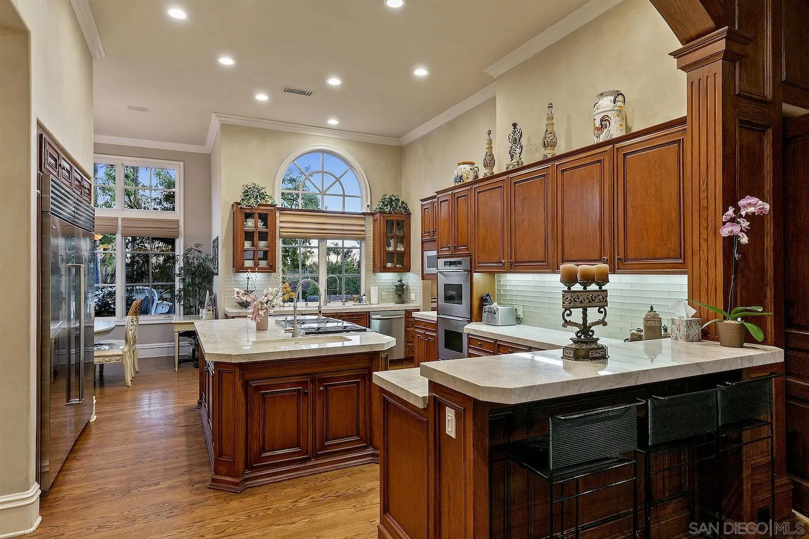 7583 St Andrews Road Rancho Santa Fe, CA 92067 - Photo 11 of 30 a kitchen with a sink and a stove with wooden floor