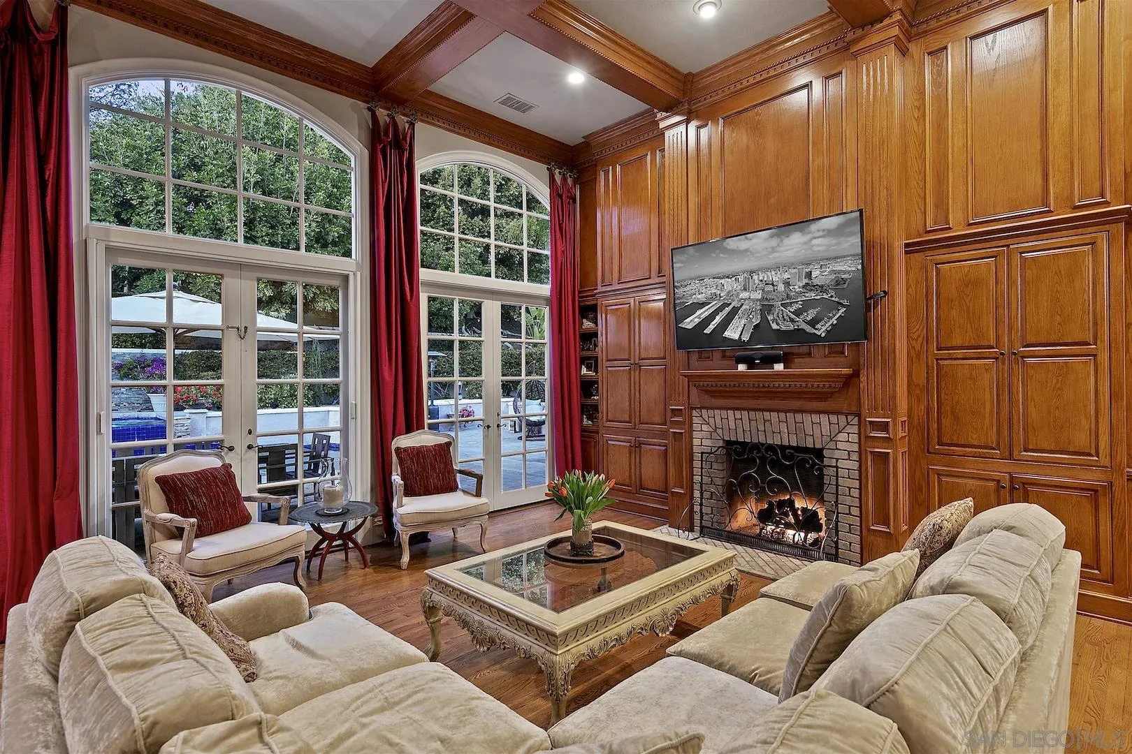 7583 St Andrews Road Rancho Santa Fe, CA 92067 - Photo 13 of 30 a living room with furniture a fireplace and a floor to ceiling window