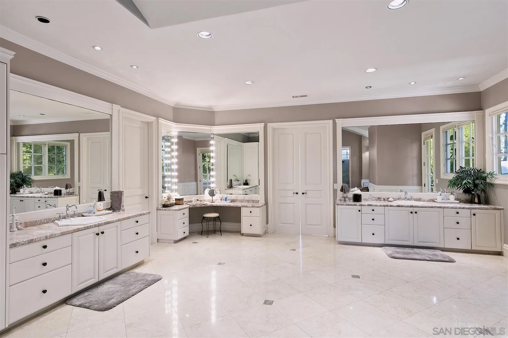 7583 St Andrews Road Rancho Santa Fe, CA 92067 - Photo 20 of 30 a large white bathroom with a large mirror vanity and a sink