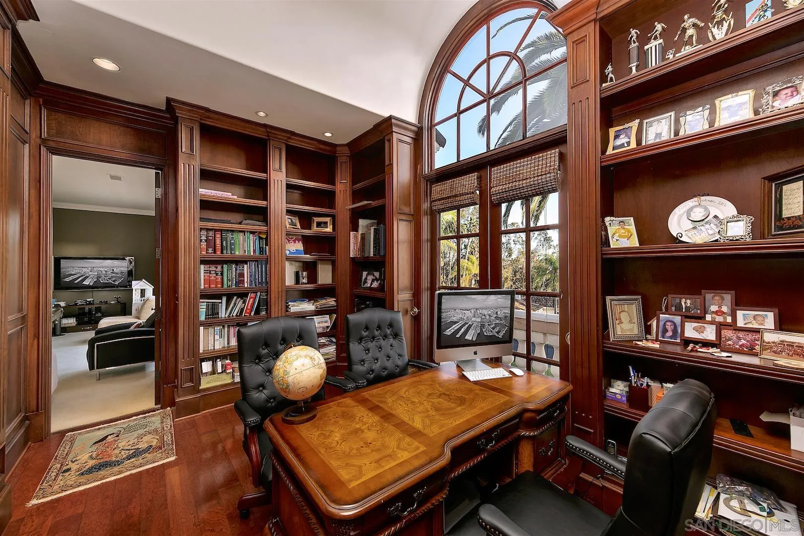 7583 St Andrews Road Rancho Santa Fe, CA 92067 - Photo 21 of 30 a living room with furniture a rug and a bookshelf