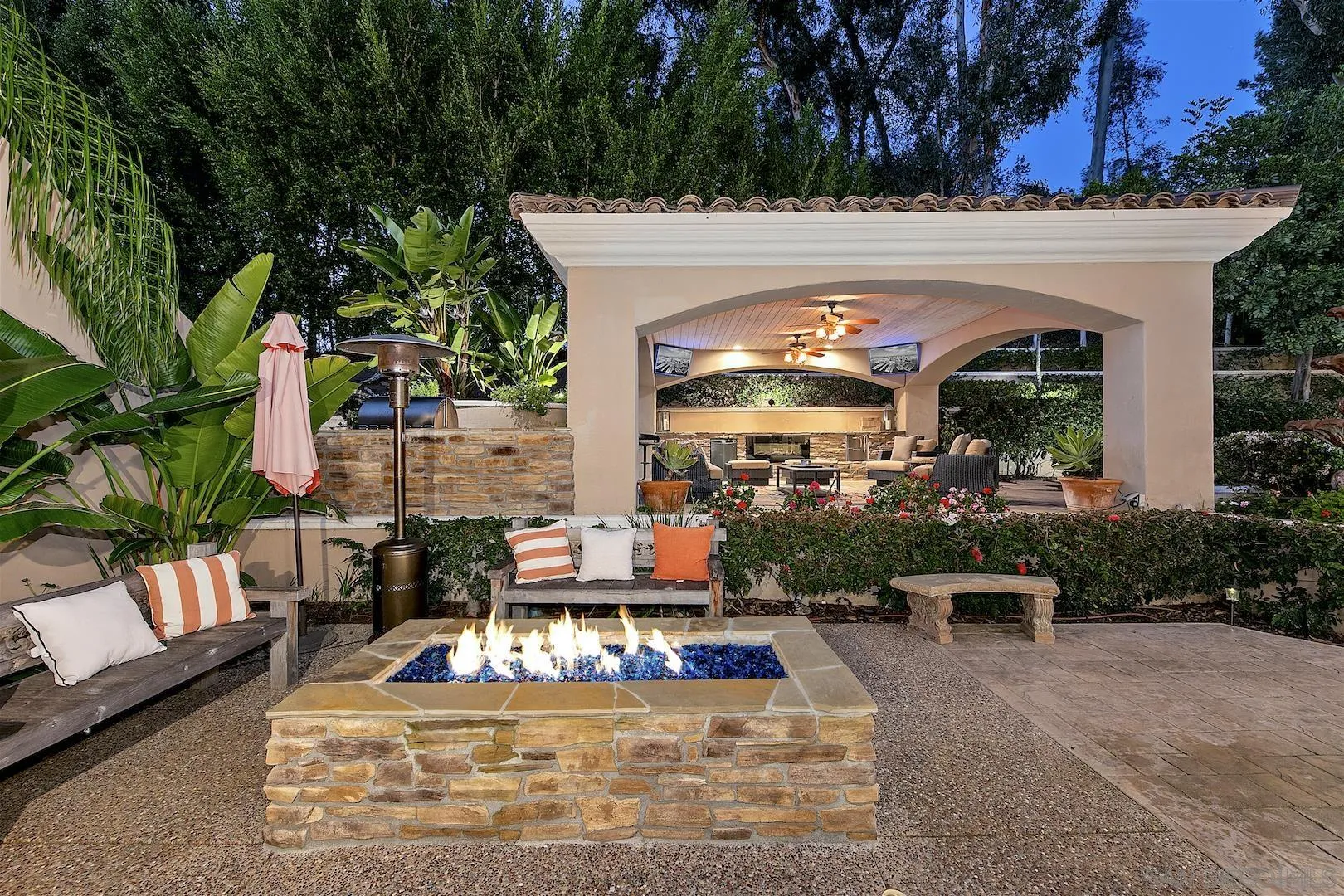 7583 St Andrews Road Rancho Santa Fe, CA 92067 - Photo 28 of 30 a view of a patio with table and chairs potted plants and a large tree