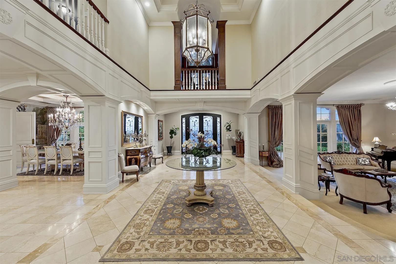 7583 St Andrews Road Rancho Santa Fe, CA 92067 - Photo 3 of 30 a living room with furniture a chandelier and a rug