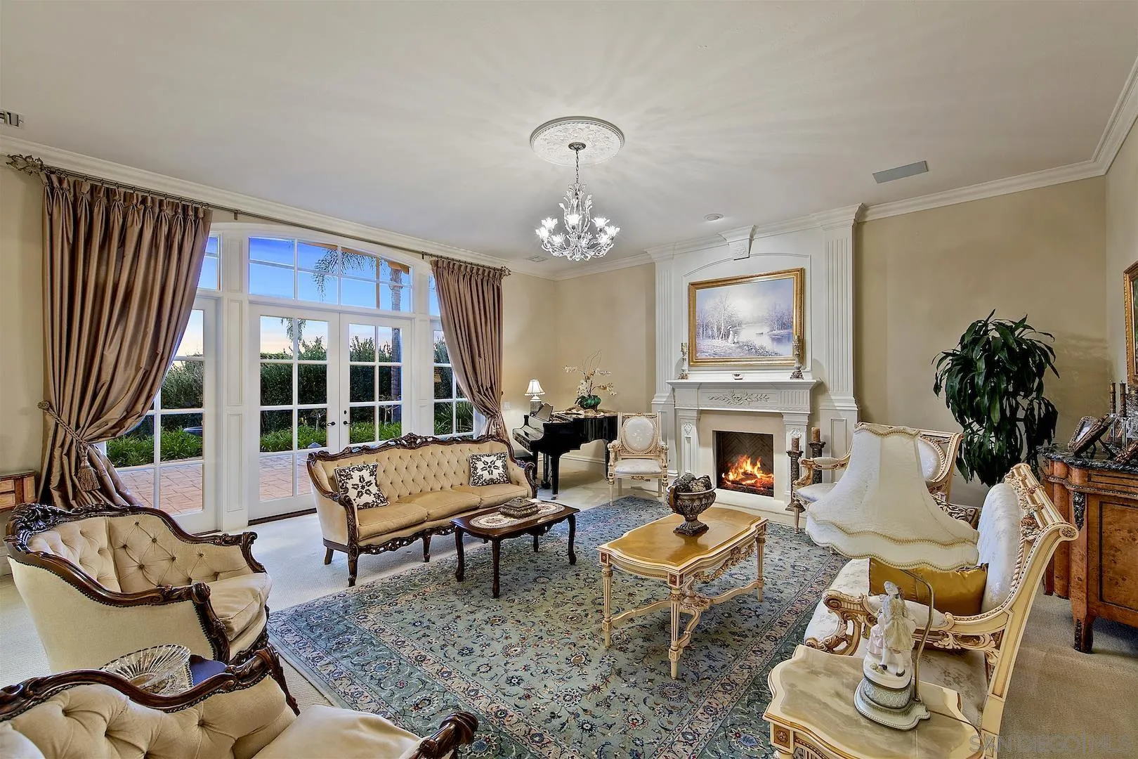7583 St Andrews Road Rancho Santa Fe, CA 92067 - Photo 6 of 30 a living room with fireplace furniture and a chandelier