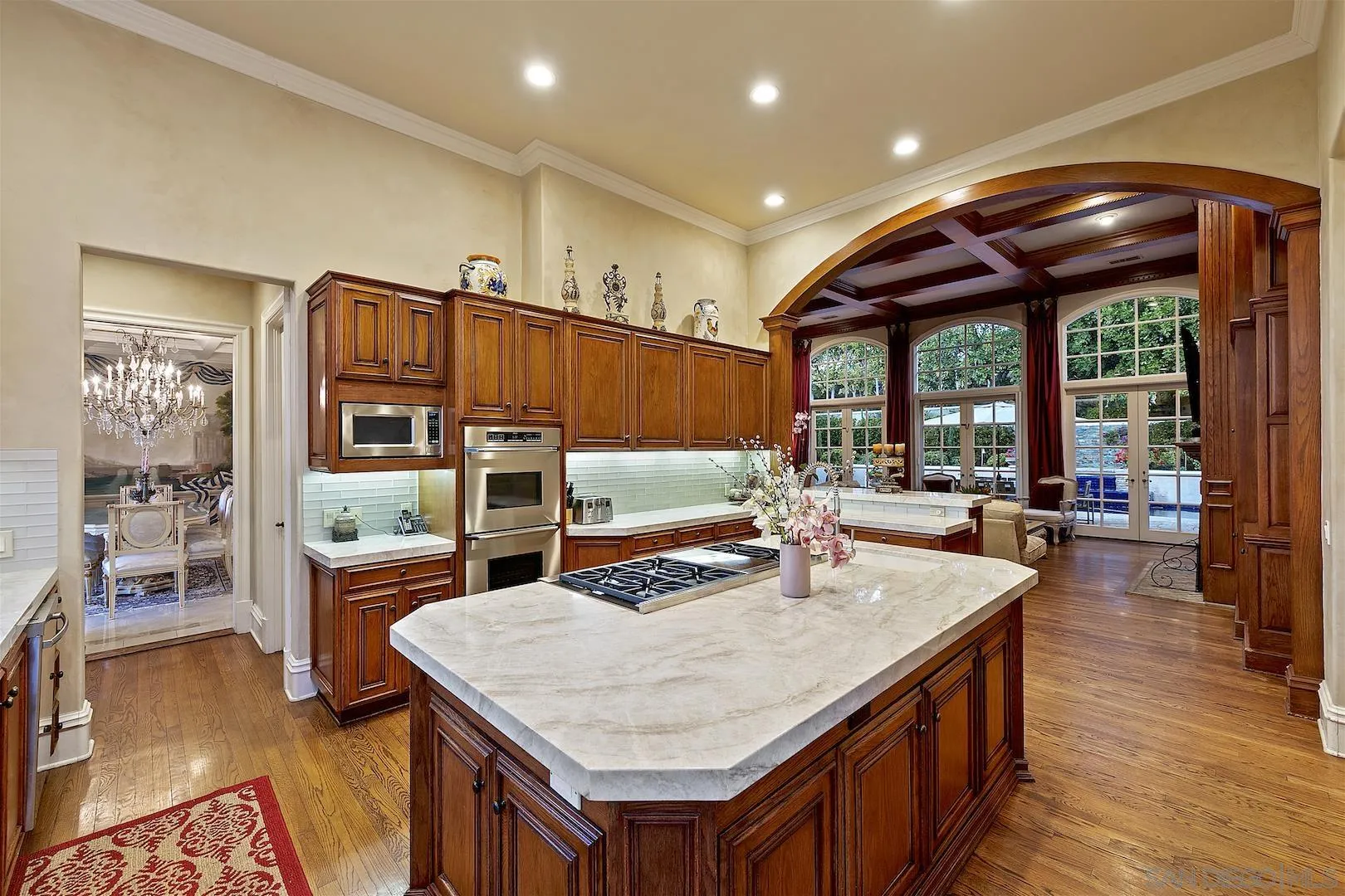 7583 St Andrews Road Rancho Santa Fe, CA 92067 - Photo 9 of 30 a kitchen with a stove a refrigerator and wooden floor