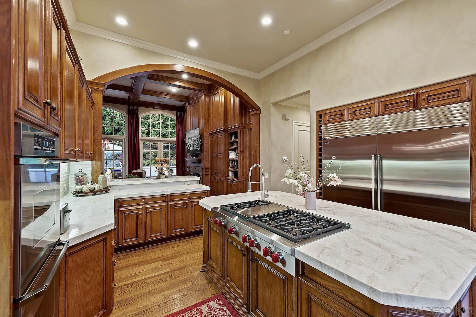 7583 St Andrews Road Rancho Santa Fe, CA 92067 - Photo 10 of 30 a kitchen with stainless steel appliances granite countertop a stove and a view of living room