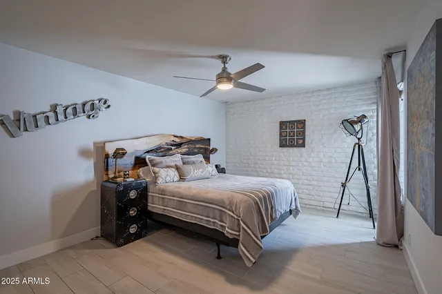 a bedroom with a bed and a ceiling fan