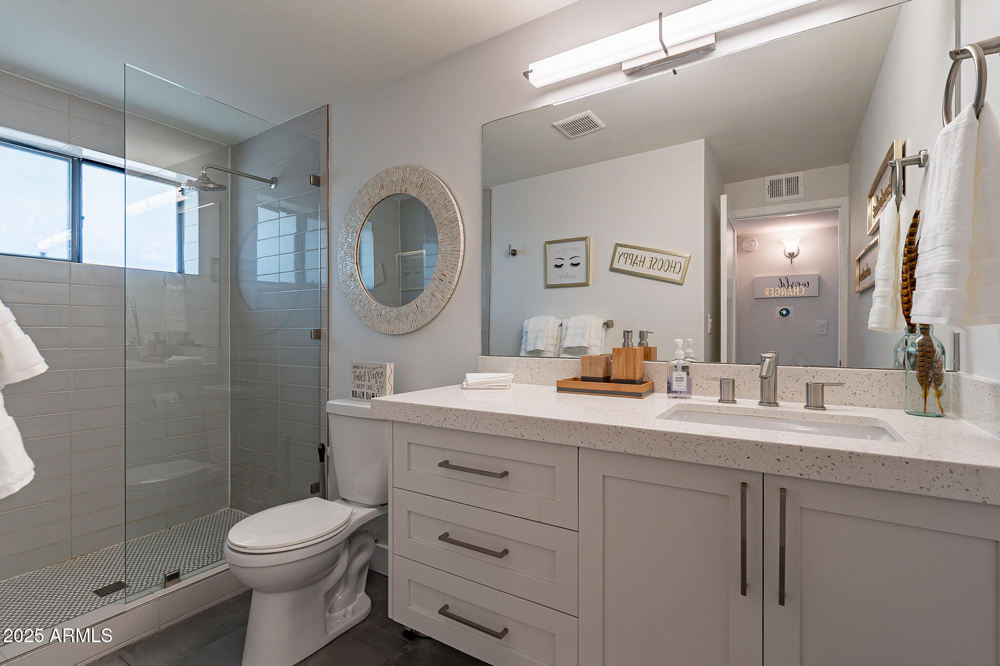 4351 North 36th Street, Unit 3 Phoenix, AZ 85018 - Photo 16 of 19 a bathroom with a double vanity sink toilet mirror and shower