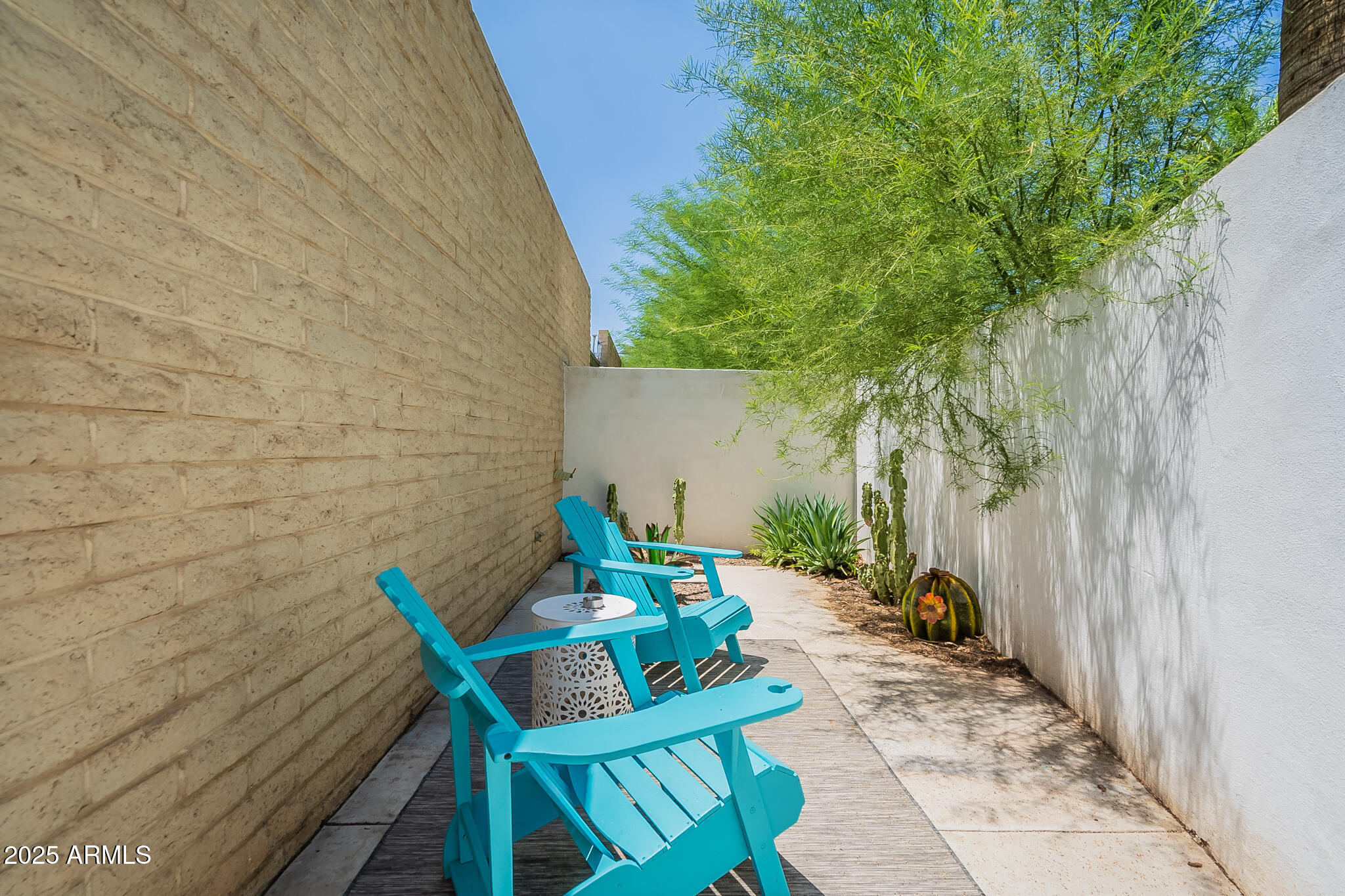 4351 North 36th Street, Unit 3 Phoenix, AZ 85018 - Photo 18 of 19 a backyard of a house with table and chairs with wooden fence