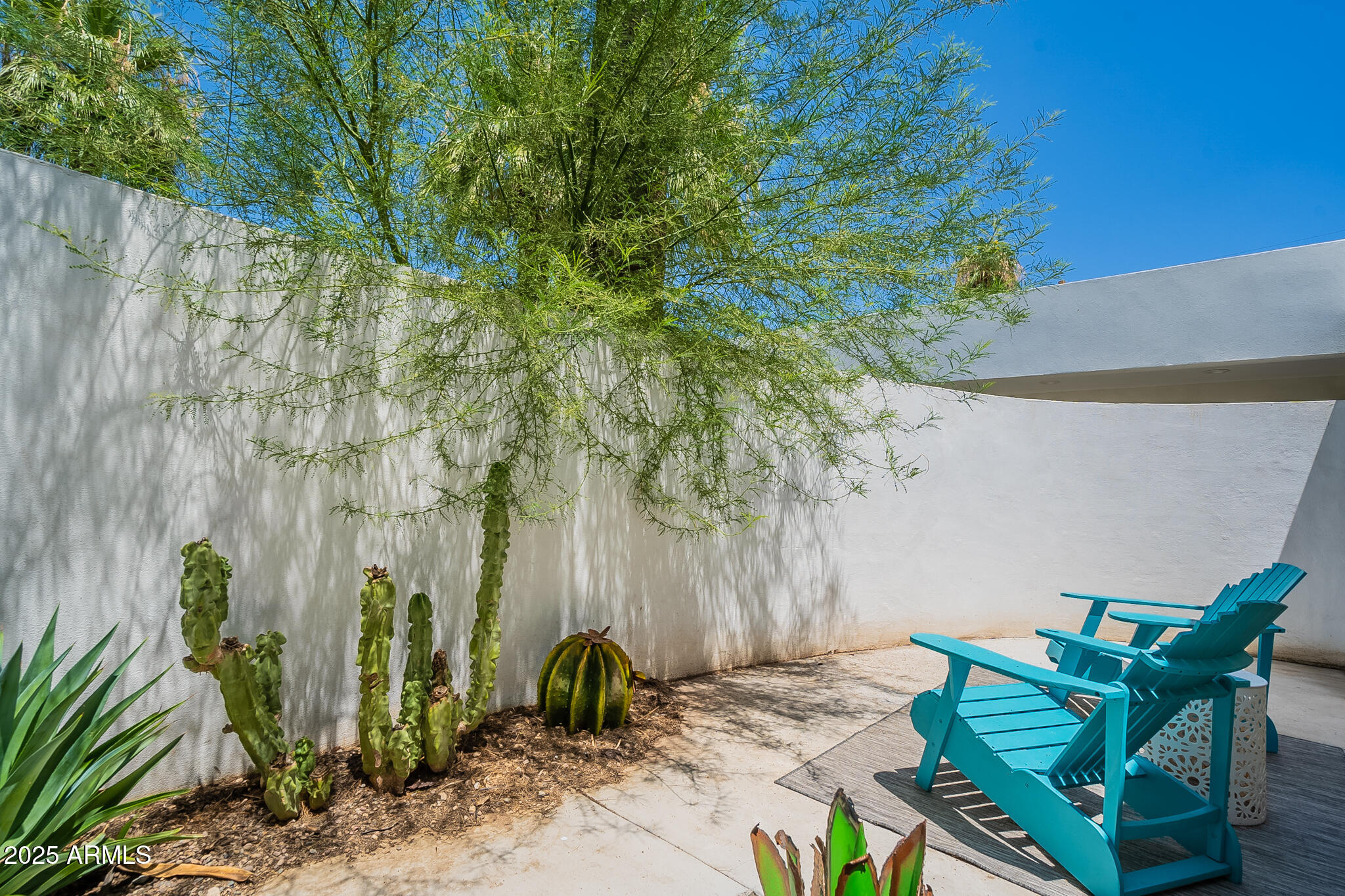 4351 North 36th Street, Unit 3 Phoenix, AZ 85018 - Photo 19 of 19 a backyard of a house with table and chairs