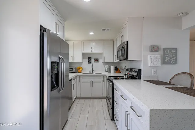 a kitchen with a sink appliances and cabinets