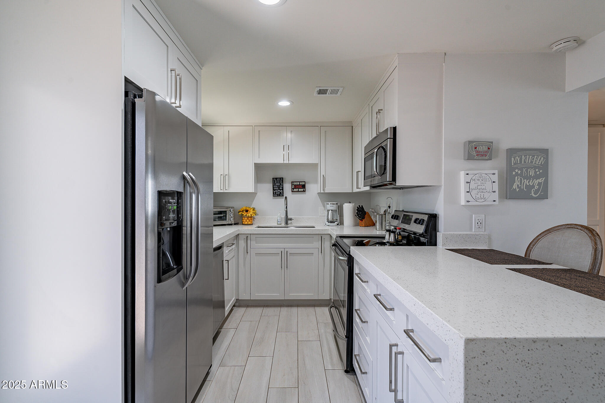 4351 North 36th Street, Unit 3 Phoenix, AZ 85018 - Photo 3 of 19 a kitchen with a sink appliances and cabinets