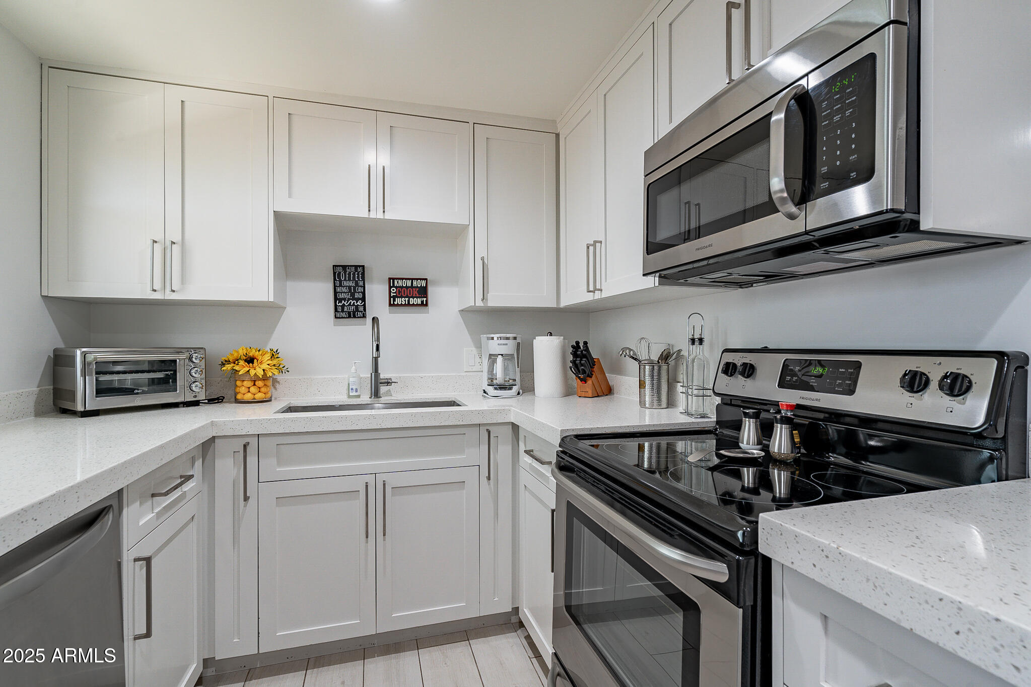 4351 North 36th Street, Unit 3 Phoenix, AZ 85018 - Photo 5 of 19 a kitchen with stainless steel appliances granite countertop a sink stove and microwave