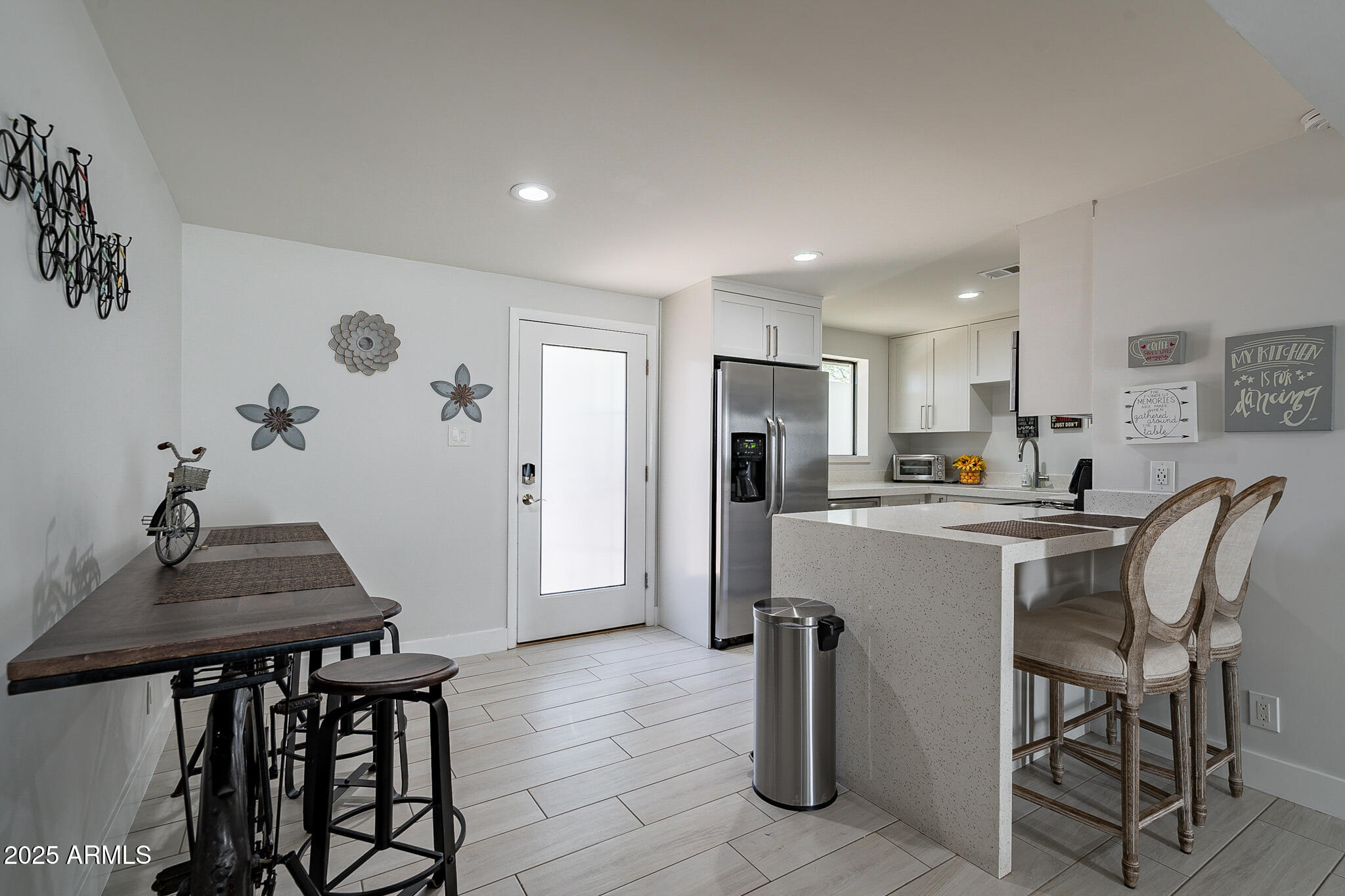 4351 North 36th Street, Unit 3 Phoenix, AZ 85018 - Photo 7 of 19 a kitchen with refrigerator and chairs