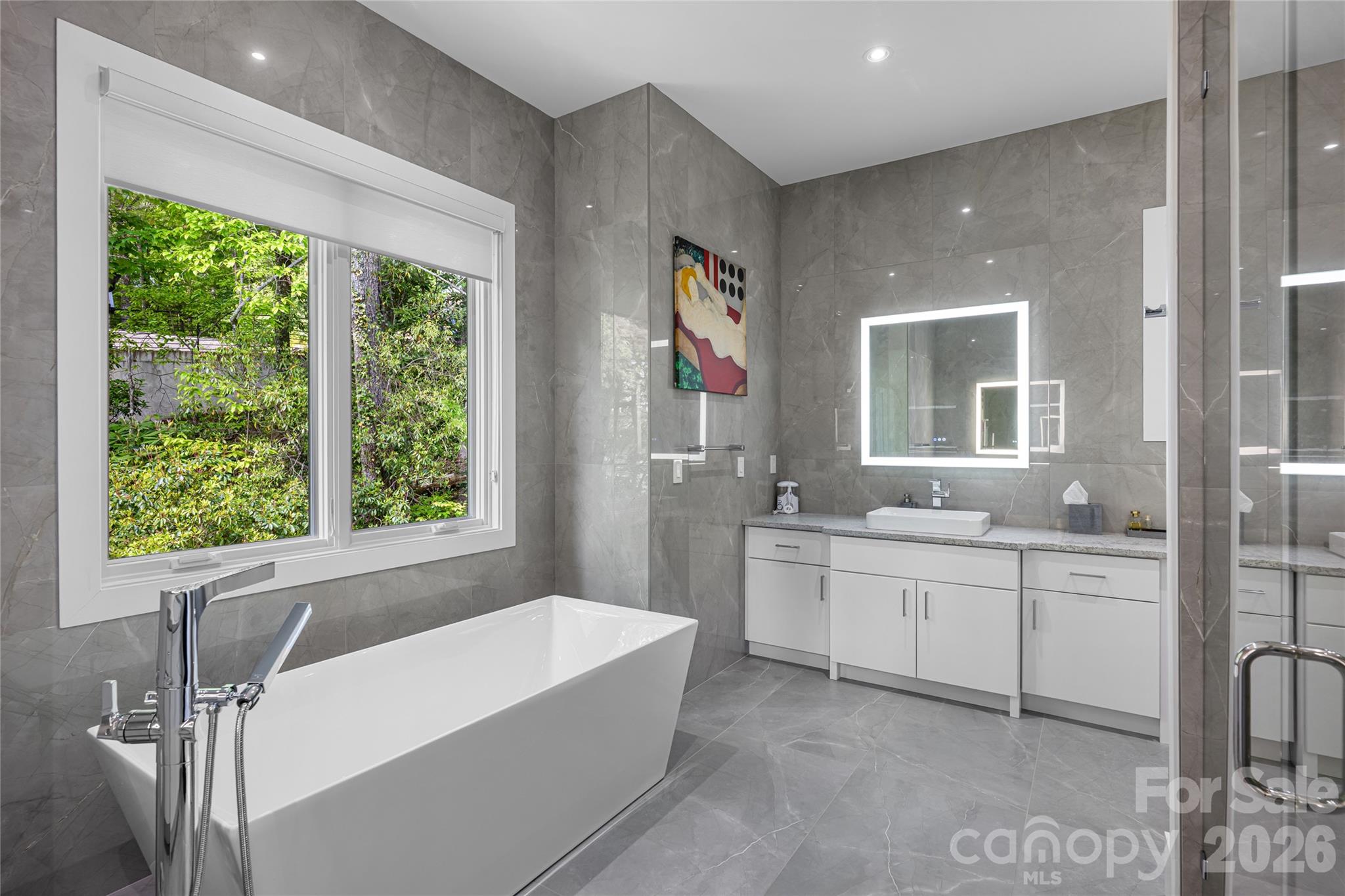 2235 Cold Mountain Road Lake Toxaway, NC 28747 - Photo 16 of 47 a spacious bathroom with a double vanity sink a large mirror and a bathtub