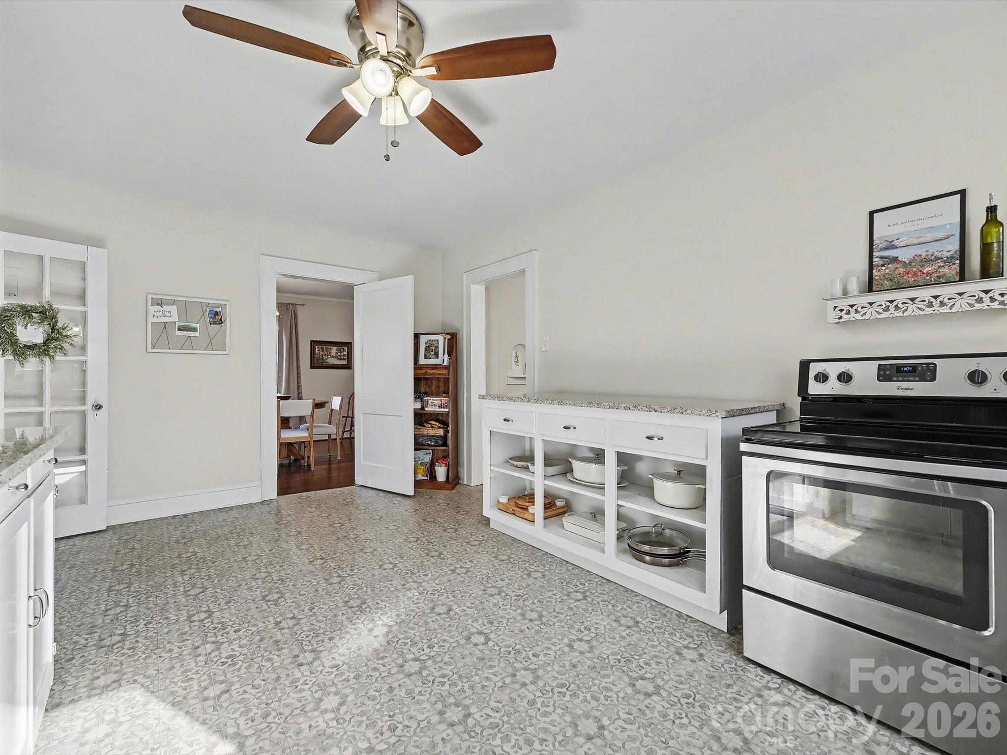 309 William Street Kannapolis, NC 28081 - Photo 13 of 38 a view of a livingroom with a fireplace a chandelier fan and wooden floor