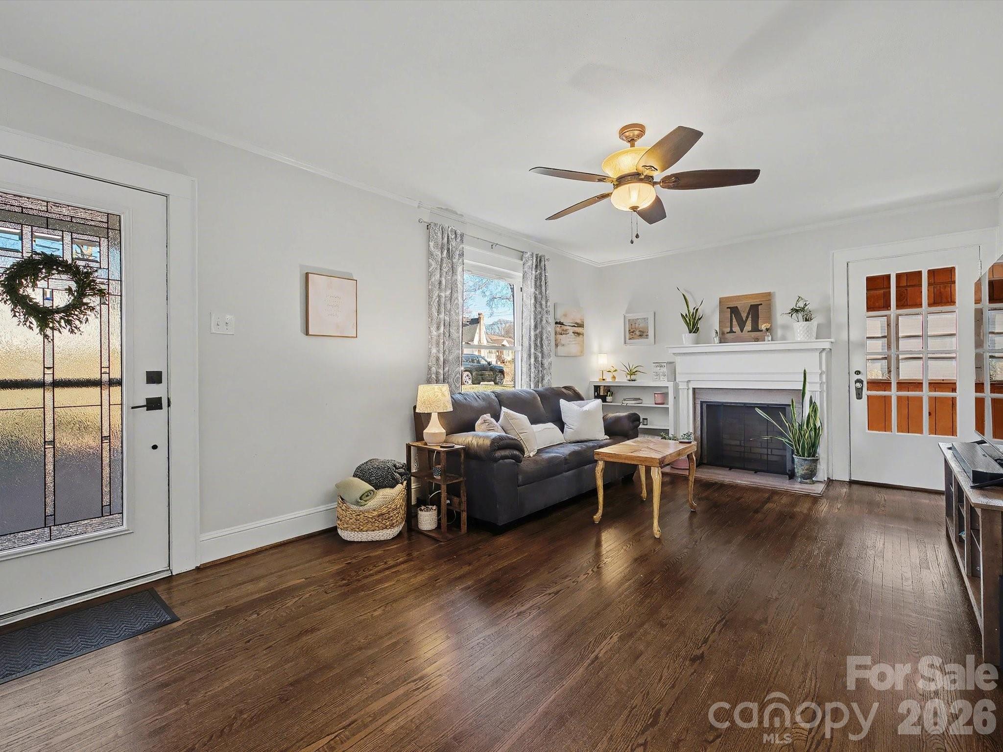 309 William Street Kannapolis, NC 28081 - Photo 2 of 38 a living room with furniture a fireplace and wooden floor