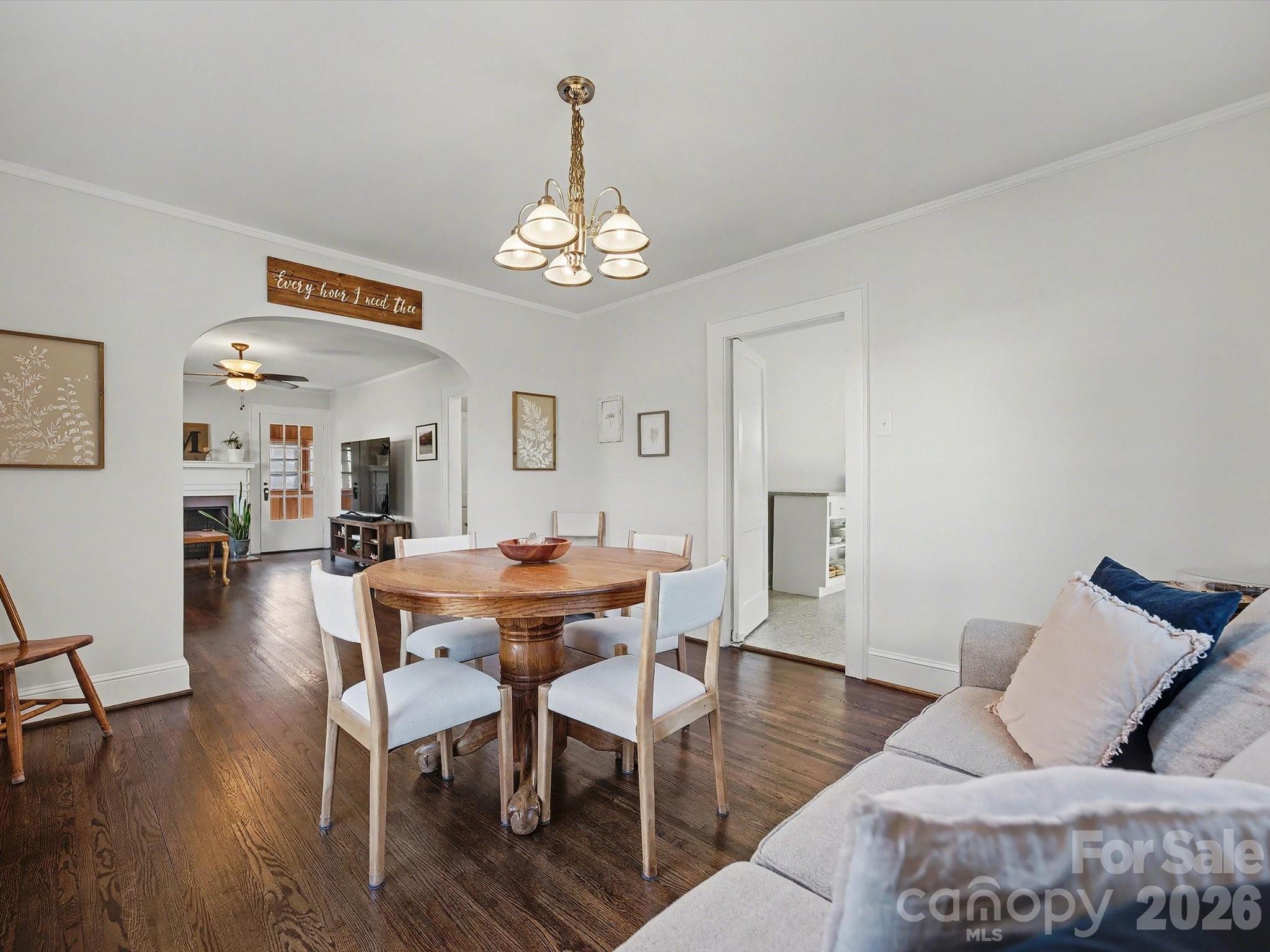 309 William Street Kannapolis, NC 28081 - Photo 8 of 38 a view of a dining room with furniture wooden floor and a chandelier