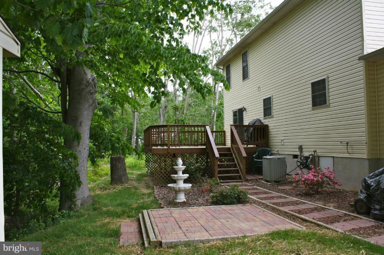 1950 Lowery Road Huntingtown, MD 20639 - Photo 13 of 28 a view of a chairs and table in backyard of the house