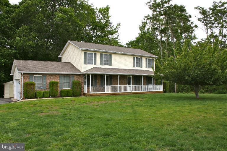 1950 Lowery Road Huntingtown, MD 20639 - Photo 14 of 28 a front view of a house with a garden