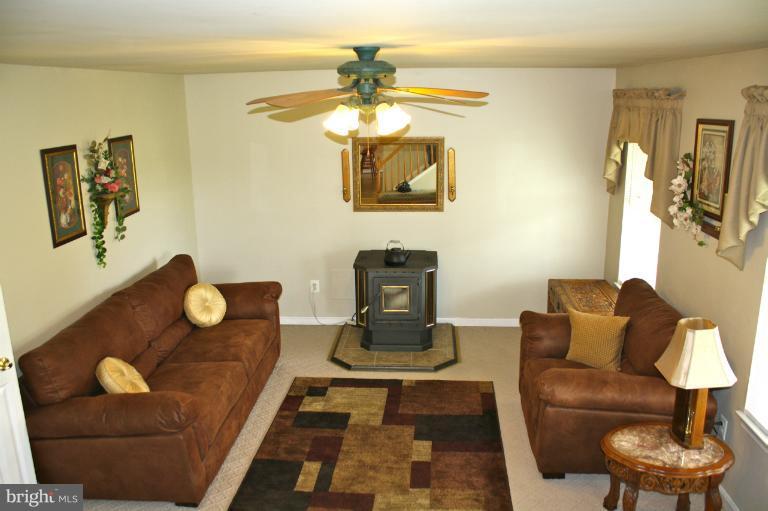 1950 Lowery Road Huntingtown, MD 20639 - Photo 17 of 28 a living room with furniture and a chandelier