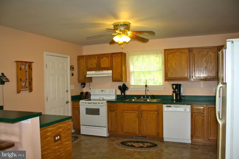1950 Lowery Road Huntingtown, MD 20639 - Photo 25 of 28 a kitchen with a sink appliances and cabinets