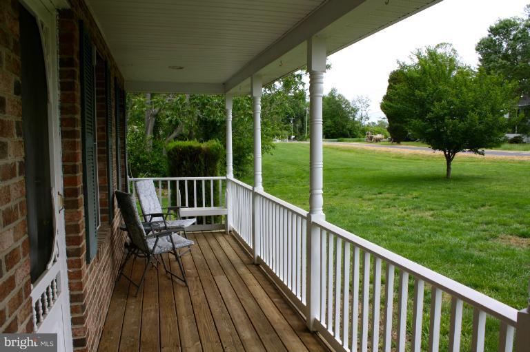 1950 Lowery Road Huntingtown, MD 20639 - Photo 5 of 28 a view of balcony with chairs and wooden fence