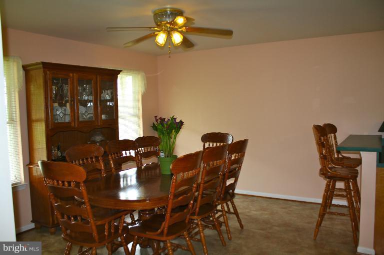 1950 Lowery Road Huntingtown, MD 20639 - Photo 6 of 28 a view of a dining room with furniture and chandelier