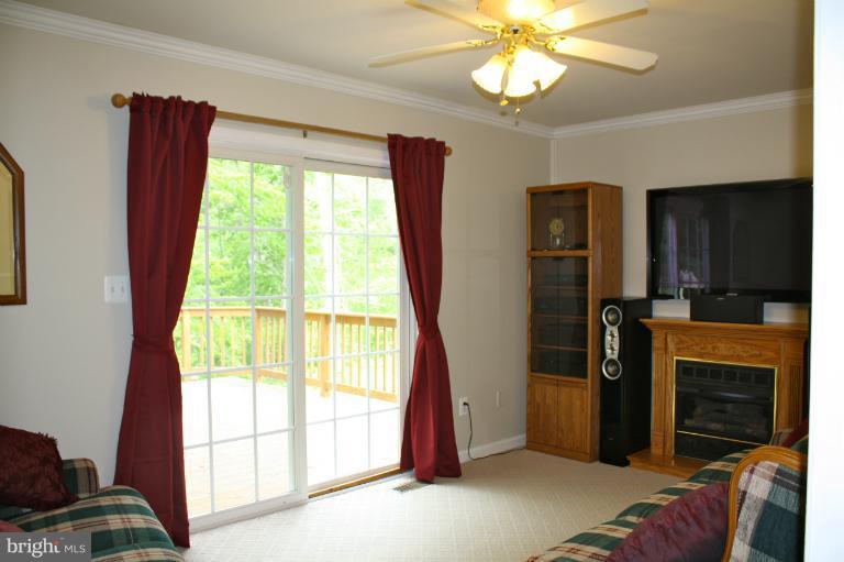 1950 Lowery Road Huntingtown, MD 20639 - Photo 7 of 28 a view of livingroom with furniture window and a fireplace
