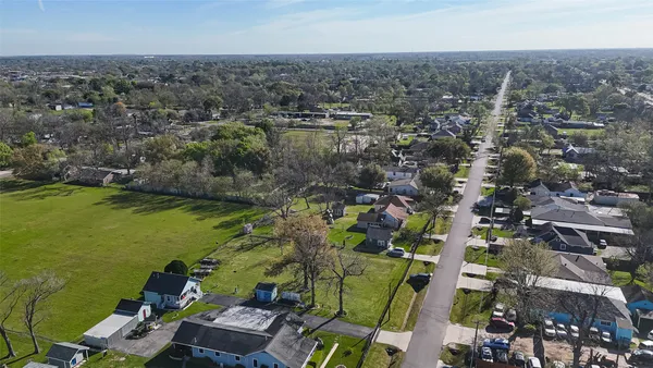 an aerial view of residential houses with city view