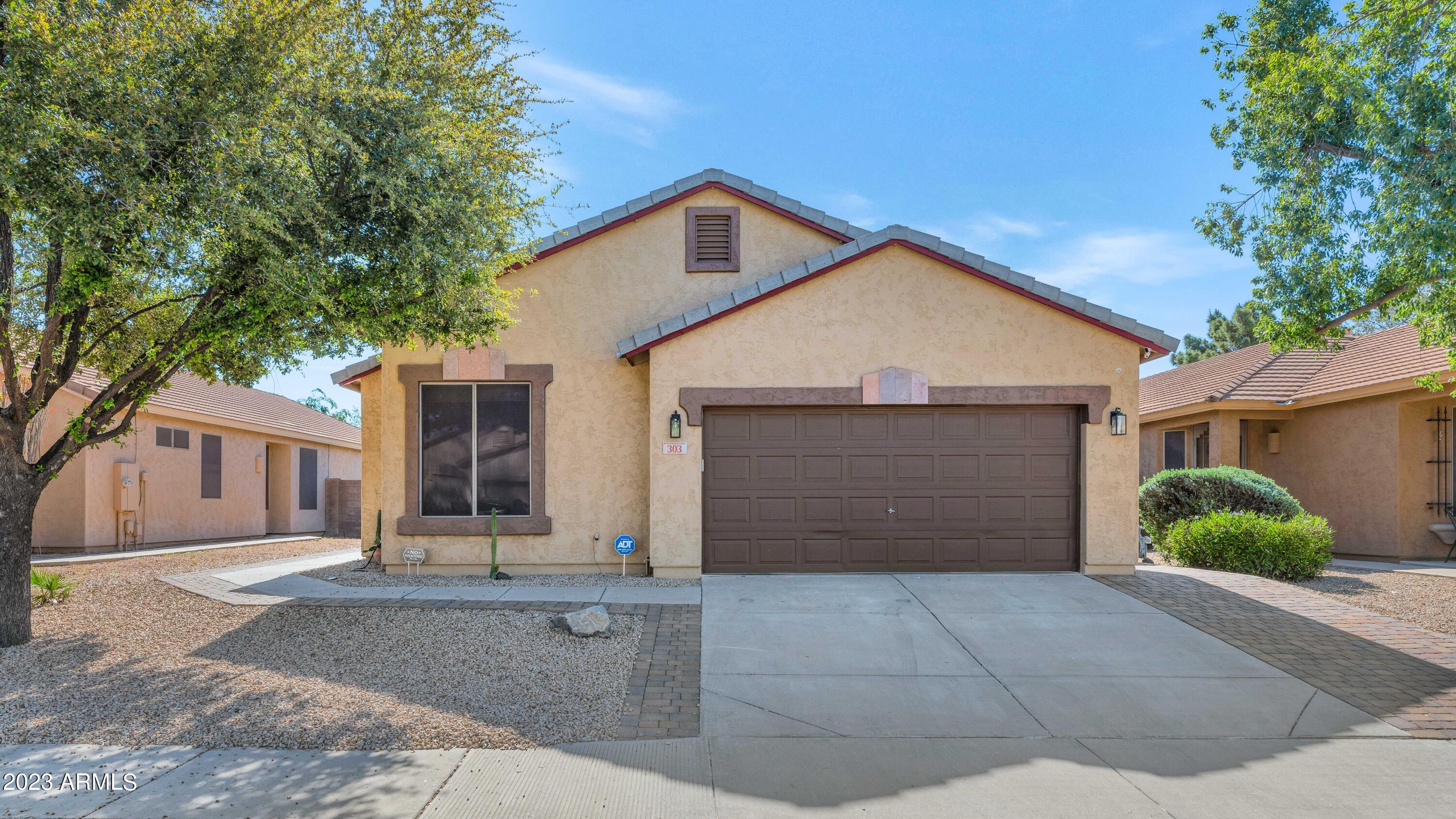 303 North Kimberlee Way Chandler, AZ 85225 - Photo 1 of 31 a front view of a house with a yard and garage