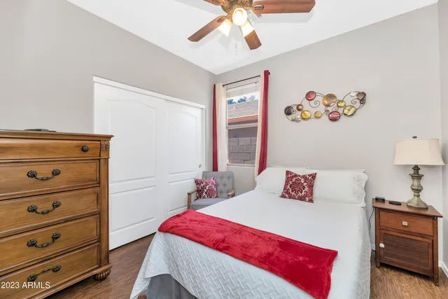 a bedroom with a bed and a painting on the wall