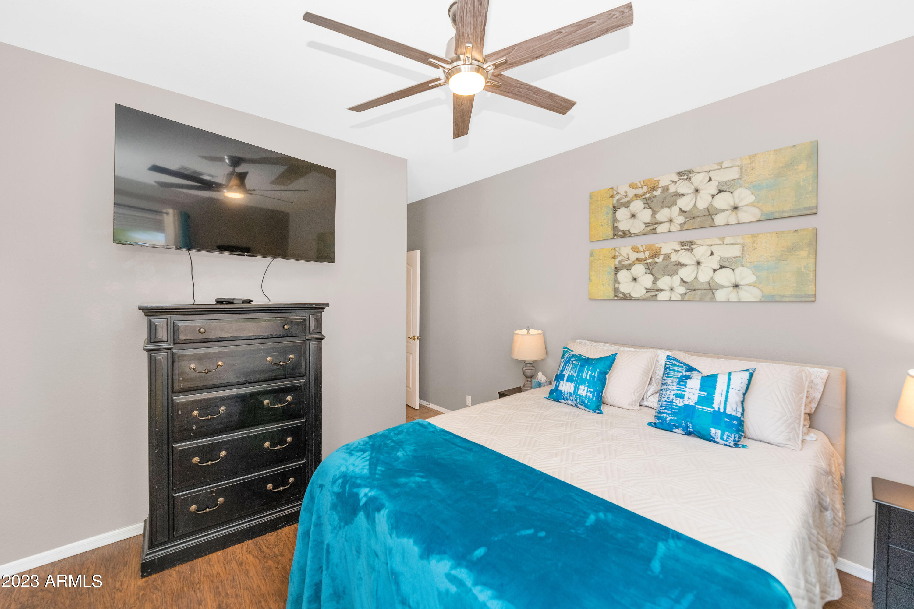 303 North Kimberlee Way Chandler, AZ 85225 - Photo 18 of 31 a bedroom with a bed and a flat screen tv