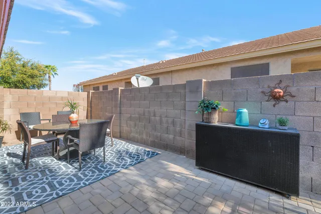 an outdoor space with swimming pool and furniture