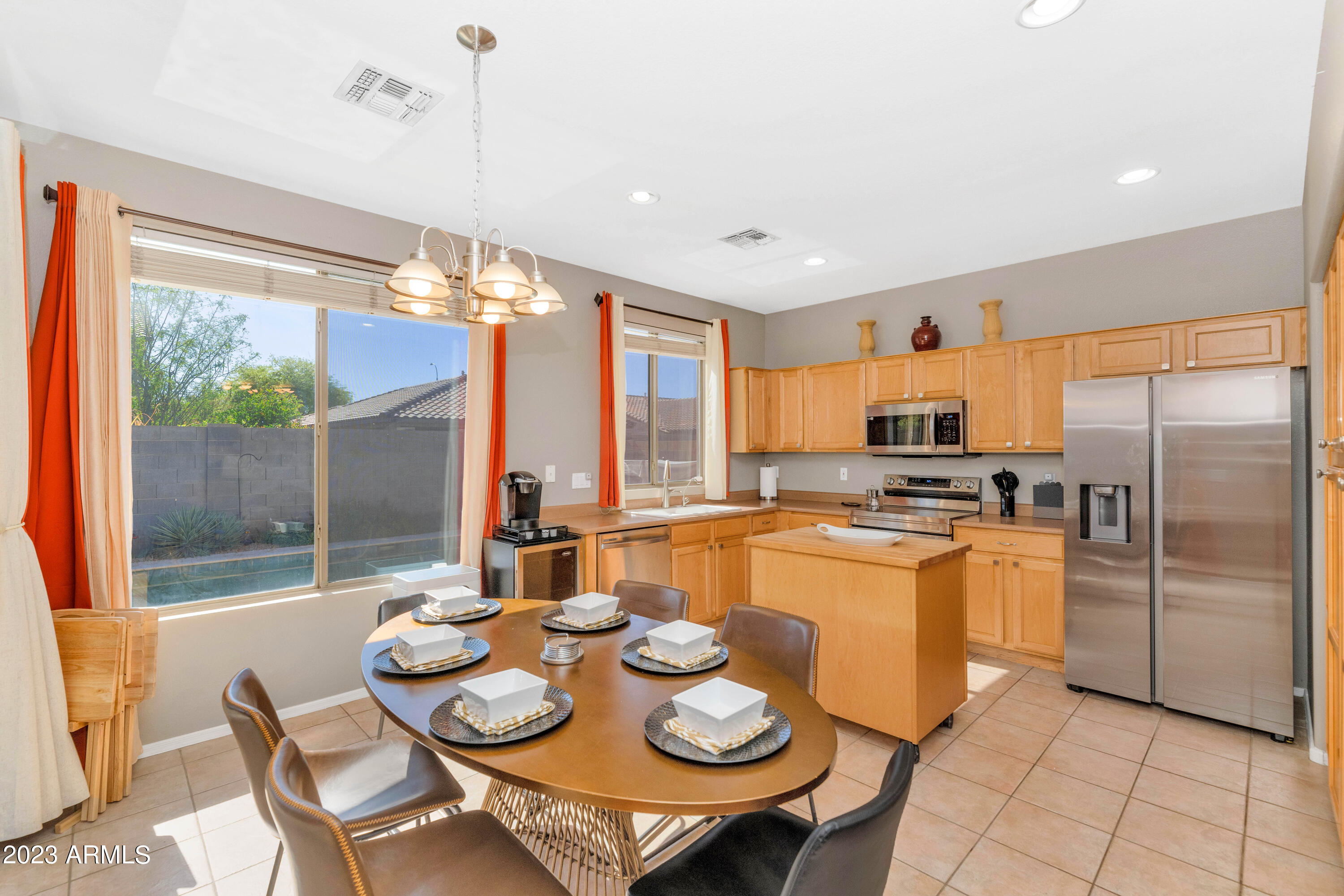 303 North Kimberlee Way Chandler, AZ 85225 - Photo 26 of 31 a kitchen with stainless steel appliances granite countertop a stove a kitchen island a table and chairs
