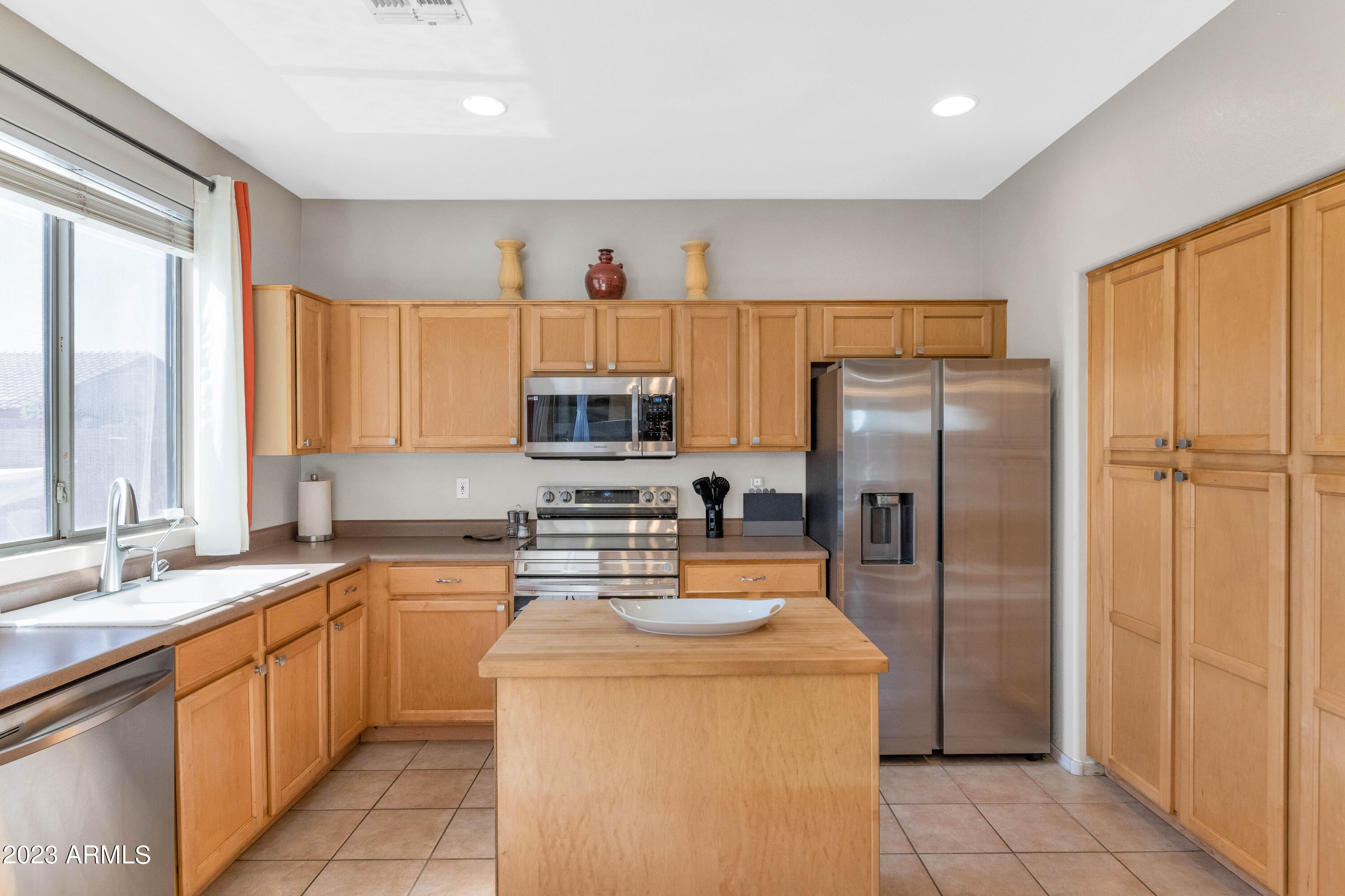 303 North Kimberlee Way Chandler, AZ 85225 - Photo 27 of 31 a kitchen with stainless steel appliances a refrigerator a sink a stove a microwave and cabinets