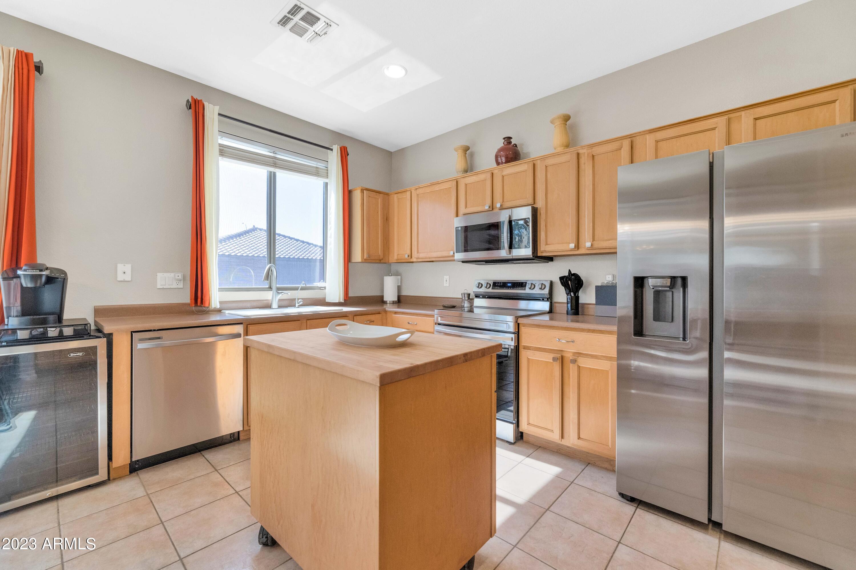 303 North Kimberlee Way Chandler, AZ 85225 - Photo 28 of 31 a kitchen with stainless steel appliances granite countertop a refrigerator a stove a sink and a window