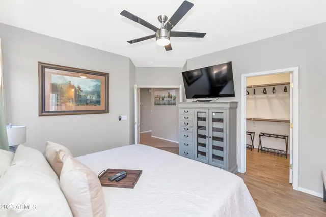 a bedroom with a bed and a flat screen tv