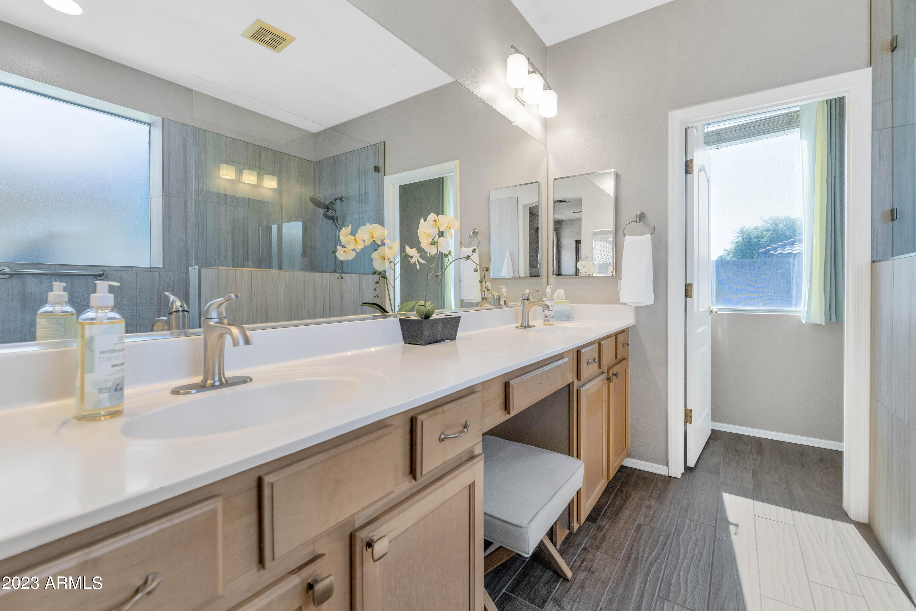 303 North Kimberlee Way Chandler, AZ 85225 - Photo 8 of 31 a bathroom with a sink double vanity granite tub shower and a mirror