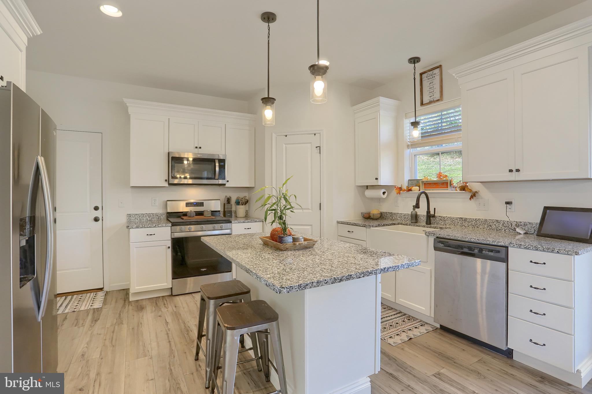 509 Elm Street Harrisburg, PA 17112 - Photo 11 of 41 a kitchen with stainless steel appliances granite countertop a sink stove and refrigerator